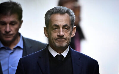 FILE: France's former president Nicolas Sarkozy leaves his residence to present himself to La Sante Prison for incarceration on a five-year prison sentence on October 21, 2025. (JULIEN DE ROSA / AFP)