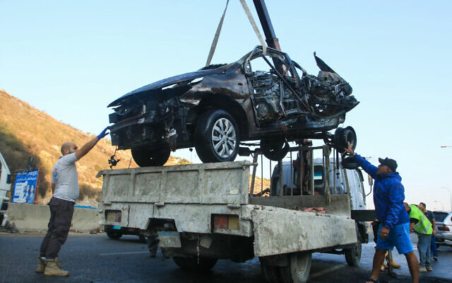 Workers remove the wreckage of a car targeted by an Israeli drone strike in the southern Lebanese village of Baissariyeh on November 10, 2025 (Mahmoud ZAYYAT / AFP)