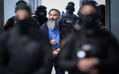 Saudi Arabian defendant Taleb Jawad al-Abdulmohsen (C) is led by judicial officers into the temporary courtroom in Magdeburg, eastern Germany on November 10, 2025, after a break of his trial over a deadly Christmas market attack in December 2024. (RONNY HARTMANN / AFP)