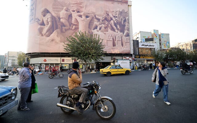 People walk past a large banner of depicting British Royal Navy personnel who were captured by the Iranian Revolutionary Guard Corps in previous years, at Enghelab (Revolution) Square in the capital Tehran on November 11, 2025. (ATTA KENARE / AFP) People walk past a large banner of depicting British Royal Navy personnel who were captured by the Iranian Revolutionary Guard Corps in previous years, at Enghelab (Revolution) Square in the capital Tehran on November 11, 2025. (ATTA KENARE / AFP)