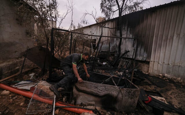 A Palestinian man inspects parts of a burnt house after an Israeli settlers attack in the village of Beit Lid, east of Tulkarm in the West Bank on November 11, 2025. (Photo by JAAFAR ASHTIYEH / AFP) A Palestinian man inspects parts of a burnt house after an Israeli settlers attack in the village of Beit Lid, east of Tulkarm in the West Bank on November 11, 2025. (Photo by JAAFAR ASHTIYEH / AFP)