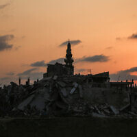 A minaret is pictured amongst destroyed buildings in Nuseirat, Gaza Strip on November 11, 2025. (Eyad Baba / AFP)