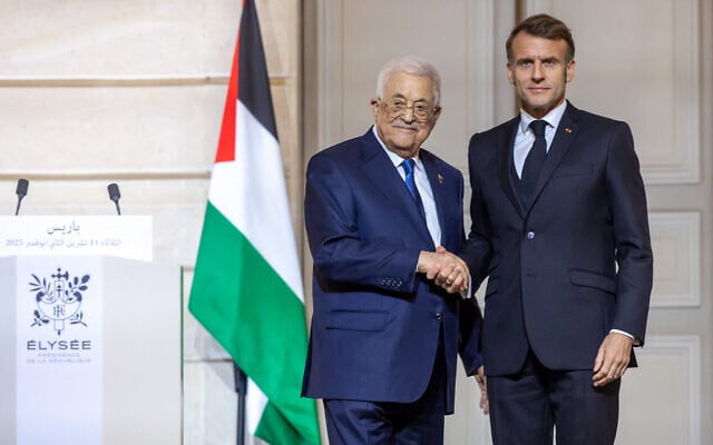 France's President Emmanuel Macron and Palestinian Authority president Mahmoud Abbas shake hands after a joint press conference at the Elysee Presidential Palace in Paris on November 11, 2025. (Christophe PETIT TESSON / POOL / AFP)