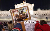 A protester holds up a placard as people take part in a protest organized by the Jewish Austrian Students' Union in front of the parliament in Vienna on November 11, 2025, against an event taking place named after Franz Dinghofer, an Austrian vice chancellor in the 1920s. (Joe Klamar/AFP)