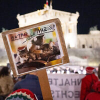 A protester holds up a placard as people take part in a protest organized by the Jewish Austrian Students' Union in front of the parliament in Vienna on November 11, 2025, against an event taking place named after Franz Dinghofer, an Austrian vice chancellor in the 1920s. (Joe Klamar/AFP)