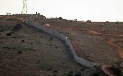 A photograph taken from the southern Lebanese village of Maroun al Ras shows a concrete barrier wall that the Israeli army began constructing south of the Blue Line, which separates Lebanon and Israel, between the northern Israeli village of Avivim and the Lebanese area of Jal al-Deir, on November 12, 2025. (Rabih DAHER / AFP) A photograph taken from the southern Lebanese village of Maroun al Ras shows a concrete barrier wall that the Israeli army began constructing south of the Blue Line, which separates Lebanon and Israel, between the northern Israeli village of Avivim and the Lebanese area of Jal al-Deir, on November 12, 2025. (Rabih DAHER / AFP)
