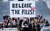A protester holds a sign related to the release of the Jeffrey Epstein case files outside the US Capitol in Washington, DC, November 12, 2025 (SAUL LOEB / AFP)