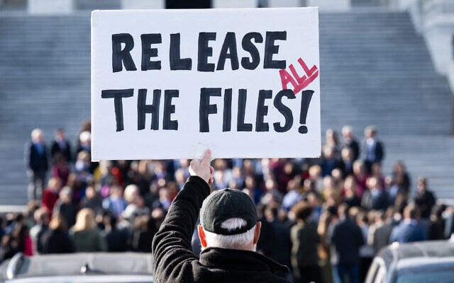 A protester holds a sign related to the release of the Jeffrey Epstein case files outside the US Capitol in Washington, DC, November 12, 2025 (SAUL LOEB / AFP) A protester holds a sign related to the release of the Jeffrey Epstein case files outside the US Capitol in Washington, DC, November 12, 2025 (SAUL LOEB / AFP)