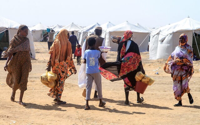 Sudanese people who fled El-Fasher prepare a meal at a camp for displaced people, in the northern Sudanese town of Al-Dabba, on November 13, 2025. (AFP)