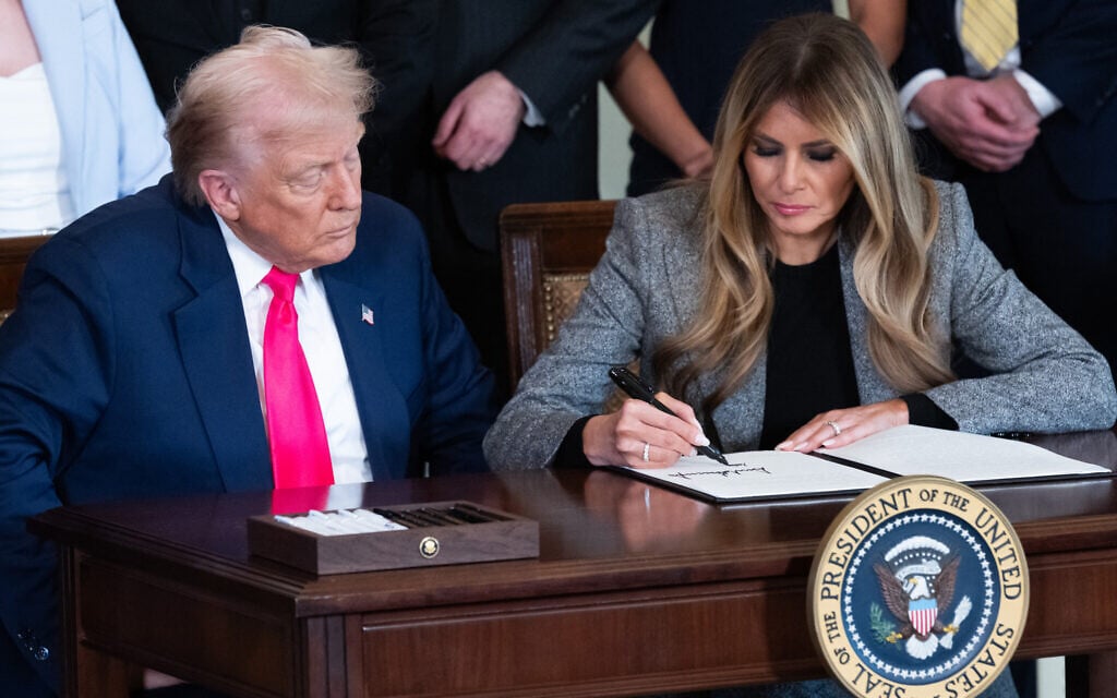 First Lady Melania Trump, alongside US President Donald Trump, signs an executive order to strengthen the foster care system, as part of the First Lady's "Fostering the Future" initiative in the East Room of the White House in Washington, DC on November 13, 2025. (SAUL LOEB / AFP)