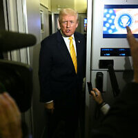 US President Donald Trump speaks to reporters aboard Air Force One en route to Palm Beach, Florida, on November 14, 2025 (Jim WATSON / AFP)