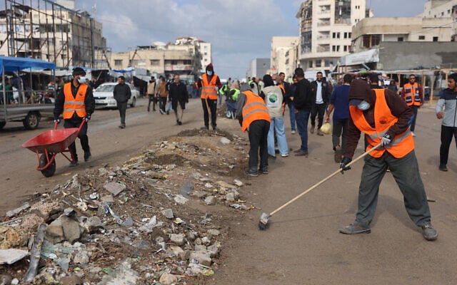 Palestinians clean the streets of Gaza City on November 15, 2025. (Omar AL-QATTAA / AFP) Palestinians clean the streets of Gaza City on November 15, 2025. (Omar AL-QATTAA / AFP)