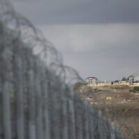 A photograph taken from Israel shows the border fence (L) separating northern Israel from southern Lebanon, with the Lebanese village of Maroun el Ras visible in the background on November 16, 2025 (Jalaa MAREY / AFP)
