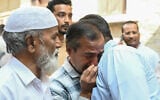 Relatives of victims, who were killed in a bus accident near the holy city of Medina, mourn in Hyderabad on November 17, 2025. (Noah SEELAM / AFP)