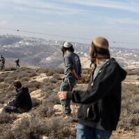 Illustrative: Israeli settlers clash with security forces in the West Bank on November 17, 2025. (Menahem KAHANA / AFP)