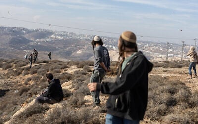 Illustrative: Israeli settlers clash with security forces in the West Bank on November 17, 2025. (Menahem KAHANA / AFP)