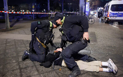 Police apprehend a suspect at the scene where a person was stabbed near the memorial of the murdered Jews of Europe in Berlin on February 21, 2025. (Odd ANDERSEN / AFP)