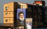 A poster of Pope Leo XIV hangs near a billboard of assassinated Hezbollah leader Hassan Nasrallah on the highway that leads to Beirut's international airport on November 20, 2025. (Photo by Anwar AMRO / AFP)