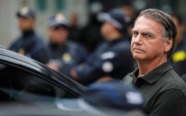 Former Brazilian President (2019-2022) Jair Bolsonaro leaves the DF Star hospital in Brasilia on September 14, 2025, after undergoing a series of medical examinations, as he remains under house arrest.  (Photo by Sergio Lima / AFP)