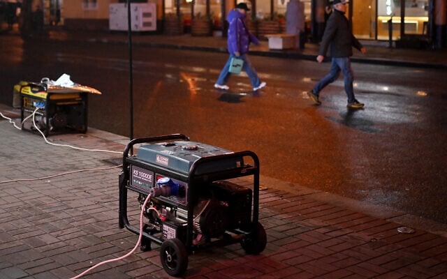 Pedestrians walk past power generators supplying electricity to restaurants during blackout hours in Kyiv on November 22, 2025, amid the Russian invasion of Ukraine. (Sergei GAPON / AFP) Pedestrians walk past power generators supplying electricity to restaurants during blackout hours in Kyiv on November 22, 2025, amid the Russian invasion of Ukraine. (Sergei GAPON / AFP)