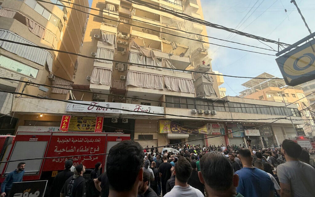 People gather looking at a residential building following an Israeli military strike in the Haret Hreik neighborhood, of Beirut's southern suburbs on November 23, 2025. (Photo by Ibrahim AMRO / AFP) People gather looking at a residential building following an Israeli military strike in the Haret Hreik neighborhood, of Beirut's southern suburbs on November 23, 2025. (Photo by Ibrahim AMRO / AFP)