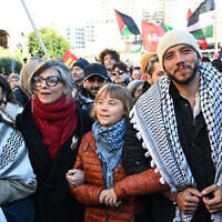 Italian United Nations (UN) Special Rapporteur Francesca Albanese (2ndL), Swedish activist of Global Sumud Flotilla, Greta Thunberg (C) and Brazilian activist Thiago Avila (R) march during an anti-Israel, pro-Palestinian demonstration as part of the nationwide general strike, in Genoa on November 28, 2025 (Piero CRUCIATTI / AFP)
