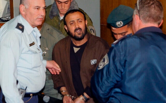 Israeli police lead Marwan Barghouti, a prominent leader of the Palestinian uprising, center, into Tel Aviv District Court, on January 19, 2003, where Barghouti is challenging Israel's authority to put him on trial. An Israeli court ruled it can try Barghouti. (AP Photo/Debbie Hill, Pool) Israeli police lead Marwan Barghouti, a prominent leader of the Palestinian uprising, center, into Tel Aviv District Court, on January 19, 2003, where Barghouti is challenging Israel's authority to put him on trial. An Israeli court ruled it can try Barghouti. (AP Photo/Debbie Hill, Pool)