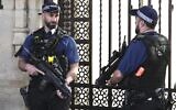Police officers stand guard outside the Houses of Parliament in London in 2023. (AP Photo/Kin Cheung)
