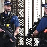 Police officers stand guard outside the Houses of Parliament in London in 2023. (AP Photo/Kin Cheung)
