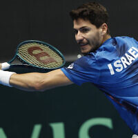 Israel's Yishai Oliel returns the ball to Germany's Maximilian Marterer of during a Davis Cup qualifier tennis match between Israel and Germany in Vilnius, Lithuania, January 31, 2025. (AP Photo/Mindaugas Kulbis)