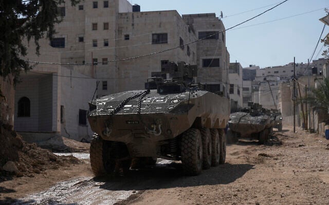Israeli army vehicles are seen during a military operation in the West Bank city of Jenin, March 11, 2025. (Majdi Mohammed/AP)