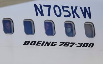 Illustrative: Venezuelan migrants deported from the United States peer through windows of an Eastern Airlines plane upon arriving at Simon Bolivar International Airport in Maiquetia, Venezuela, Sunday, March 30, 2025. (AP Photo/Cristian Hernandez)