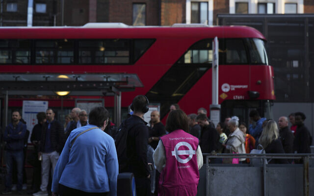 Illustrative: Transport for London workers help commuters get onboard buses, during a strike by members of the Rail, Maritime and Transport union (RMT), in central London, September 8, 2025. (AP Photo/Joanna Chan) Illustrative: Transport for London workers help commuters get onboard buses, during a strike by members of the Rail, Maritime and Transport union (RMT), in central London, September 8, 2025. (AP Photo/Joanna Chan)