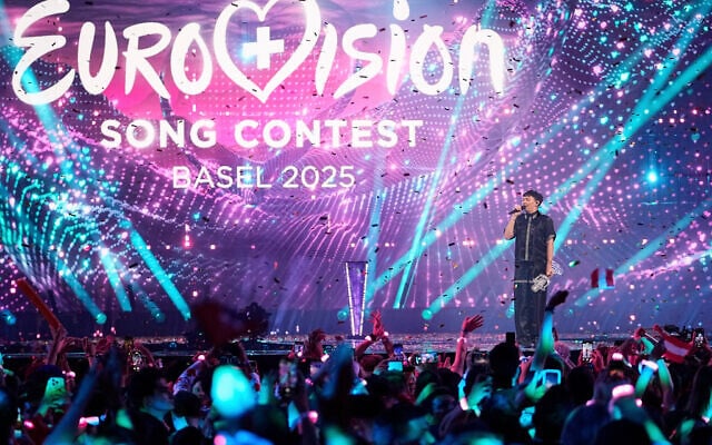 JJ from Austria stands on the stage with the trophy after winning the Grand Final of the 69th Eurovision Song Contest, in Basel, Switzerland, May 18, 2025. (Martin Meissner/AP)