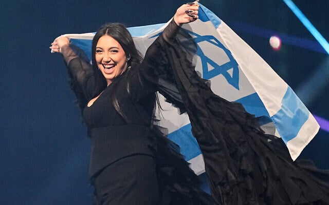 Yuval Raphael from Israel holds the national flag during a dress rehearsal for the Grand Final of the 69th Eurovision Song Contest, in Basel, Switzerland, May 16, 2025. (Martin Meissner/AP)