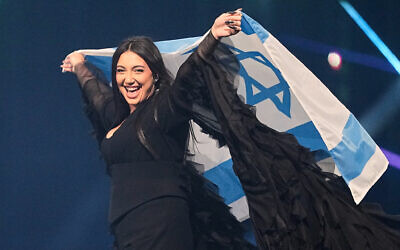 Yuval Raphael from Israel holds the national flag during a dress rehearsal for the Grand Final of the 69th Eurovision Song Contest, in Basel, Switzerland, May 16, 2025. (Martin Meissner/AP)