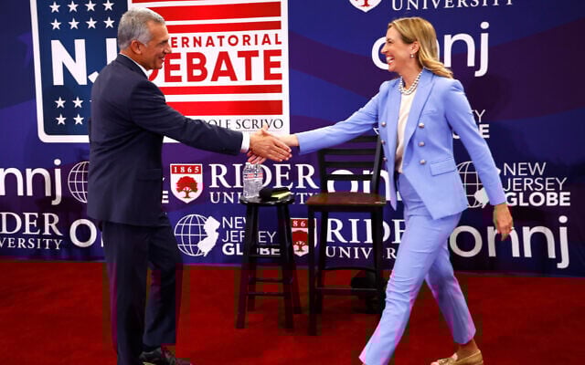 FILE - Republican candidate Jack Ciattarelli, left, shake hands with Democratic candidate for governor Mikie Sherrill, right, before a New Jersey gubernatorial debate, September 21, 2025, in Lawrenceville, New Jersey. (AP Photo/Noah K. Murray, File)
