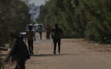 Masked Hamas gunmen take positions in Khan Younis, southern Gaza Strip, ahead of handing over Israeli hostages to the Red Cross, Oct. 13, 2025. (AP Photo/Abdel Kareem Hana)