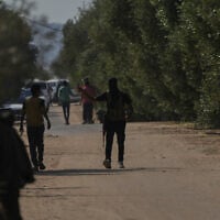 Masked Hamas gunmen take positions in Khan Younis, southern Gaza Strip, ahead of handing over Israeli hostages to the Red Cross, Oct. 13, 2025. (AP Photo/Abdel Kareem Hana)