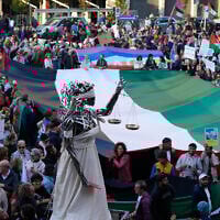 People protest against the participation of the Israeli national team in the 2026 Soccer World Cup qualification match against Italy being played in Udine, Italy, October 14, 2025. (AP Photo/Luca Bruno, File)