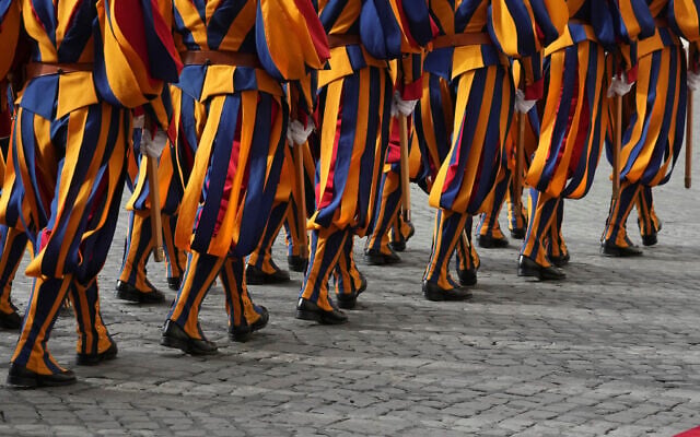 Swiss Guards march prior to the arrival of Britain's King Charles III and Queen Camilla arrive in the St. Damasus Courtyard at the Vatican for a state visit, where they will meet with Pope Leo XIV and pray with him in the Sistine Chapel, October 23, 2025. (AP Photo/ Andrew Medichini) Swiss Guards march prior to the arrival of Britain's King Charles III and Queen Camilla arrive in the St. Damasus Courtyard at the Vatican for a state visit, where they will meet with Pope Leo XIV and pray with him in the Sistine Chapel, October 23, 2025. (AP Photo/ Andrew Medichini)