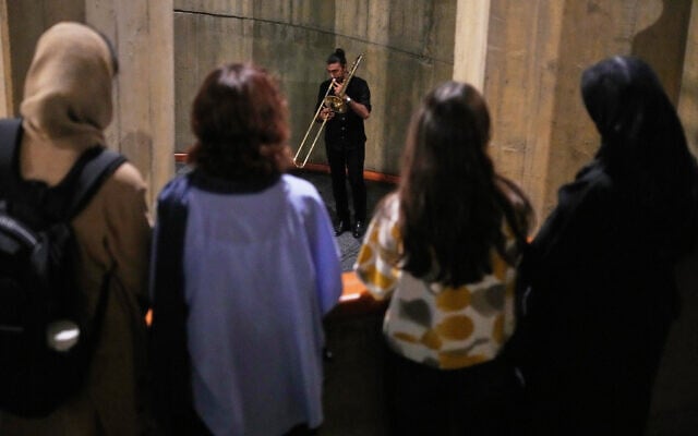 Women watch as a man plays trombone as people listen at the Tehran Museum of Contemporary Art, Iran, Oct. 26, 2025. (AP Photo/Vahid Salemi) Women watch as a man plays trombone as people listen at the Tehran Museum of Contemporary Art, Iran, Oct. 26, 2025. (AP Photo/Vahid Salemi)