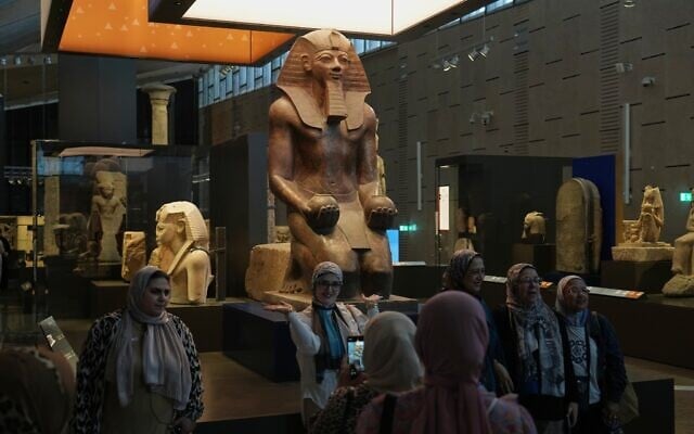 Visitors pose for a group photo under Hatshepsut statue, at the Grand Egyptian Museum in Giza, Egypt, May 23, 2025. (AP Photo/Amr Nabil) Visitors pose for a group photo under Hatshepsut statue, at the Grand Egyptian Museum in Giza, Egypt, May 23, 2025. (AP Photo/Amr Nabil)