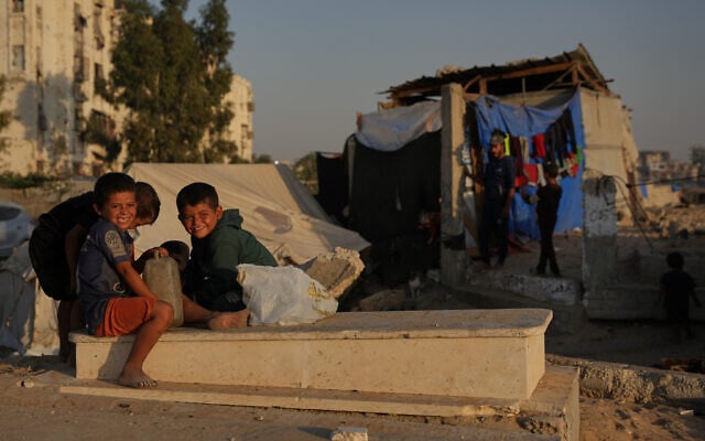Palestinian children sit on a grave near makeshift tents for displaced people that were set up in a cemetery in Khan Younis, in the southern Gaza Strip, October 31, 2025. (AP Photo/Abdel Kareem Hana) Palestinian children sit on a grave near makeshift tents for displaced people that were set up in a cemetery in Khan Younis, in the southern Gaza Strip, October 31, 2025. (AP Photo/Abdel Kareem Hana)