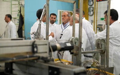 Iranian President Masoud Pezeshkian listens to explanations as he visits the country's nuclear achievements during his tour to the Atomic Energy Organization in Tehran, Iran, in a photo released on November 2, 2025. (Atomic Energy Organization of Iran via AP)