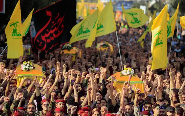 Hezbollah fighters and supporters raise their fists and chant slogans as they march in the funeral procession of five comrades killed in Israeli strikes in recent days, in the southern town of Nabatieh, Lebanon, November 2, 2025. (AP Photo/Mohammad Zaatari) Hezbollah fighters and supporters raise their fists and chant slogans as they march in the funeral procession of five comrades killed in Israeli strikes in recent days, in the southern town of Nabatieh, Lebanon, November 2, 2025. (AP Photo/Mohammad Zaatari)