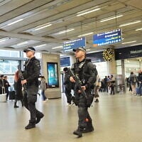 Armed police officers patrol at St Pancras International train station in London, England, November 3, 2025. (Yui Mok/PA via AP)