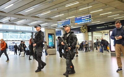 Armed police officers patrol at St Pancras International train station in London, England, November 3, 2025. (Yui Mok/PA via AP)