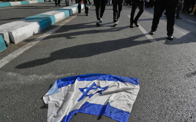 An Israeli flag is placed on the ground during an annual rally in front of the former US Embassy in Tehran, celebrating the anniversary of the 1979 takeover of the embassy, Nov. 4, 2025. (AP/Vahid Salemi)