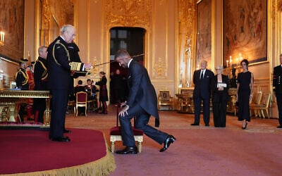 Sir David Beckham is made a Knight Bachelor by Britain's King Charles III during an Investiture ceremony at Windsor Castle, Berkshire, England, on November 4, 2025. (Jonathan Brady/PA via AP)